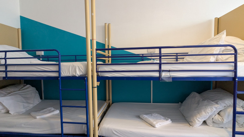 Bunk beds in a dorm with teal walls